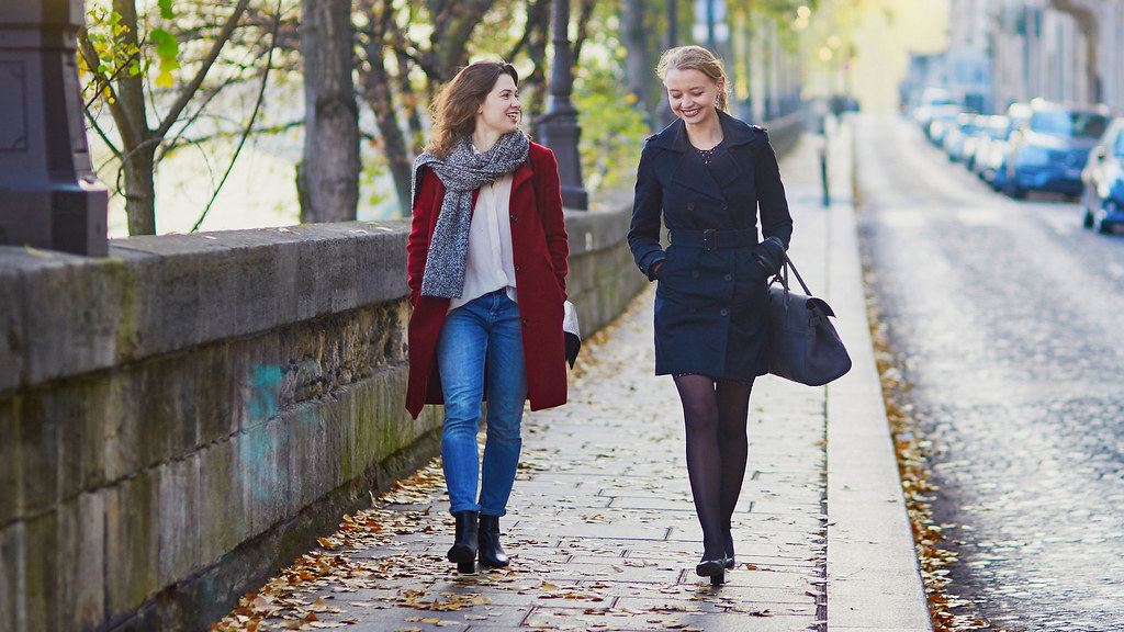 Two women walking street abroad