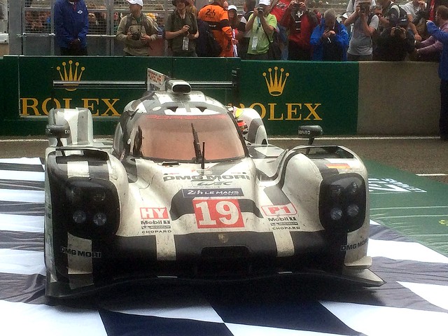 The winning Porsche 919 Hybrid of Nico Hulkenberg, Nick Tandy & Earl Bamber under the podium at the 2015 Le Mans