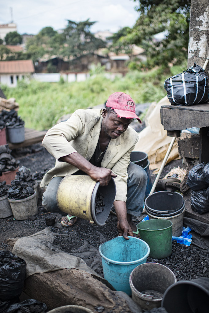 Charcoal seller Nkamdoum Hans is 38 years old and sells at Mokolo Market. Yaoundé, Cameroon.