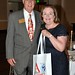 Outgoing DG Rusine Sinclair, carrying a bag from the recent Atlanta Rotary International Convention. To Rusine's left is her husband Dick