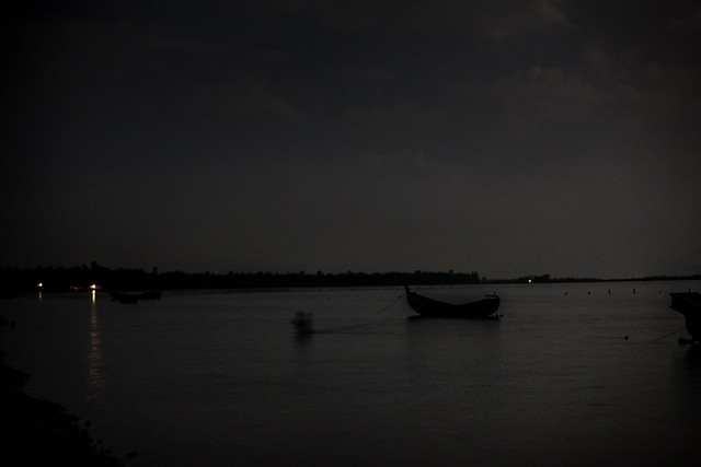 A lone boatman brings in his boat in moonlight 8717