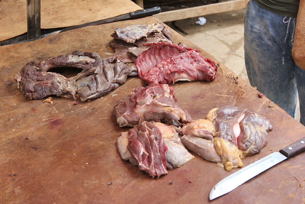By late morning, just a few pieces of meat, including deer and boruga (Agouti paca), remain on a table at...