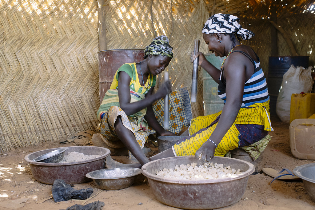 Zenab (left), 33 years old, and Ramatou, 38 years old, both farmers, crush gold ore. Most women have two jobs...