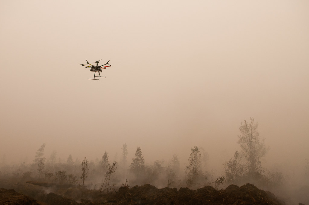 An Unmanned Aerial Vehicle (UAV) flies over burning peat. Outside Palangka Raya, Central Kalimantan.