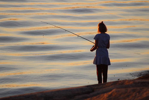 girl fishing angling rod sea fjord evening sunset summer outdoor