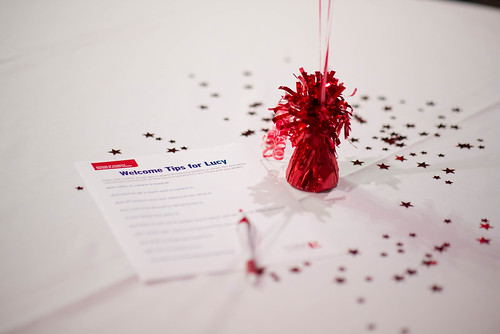 A decorated table at the Sizzlin' Success Celebration with a "Tips for Lucy" questionnaire at the ready