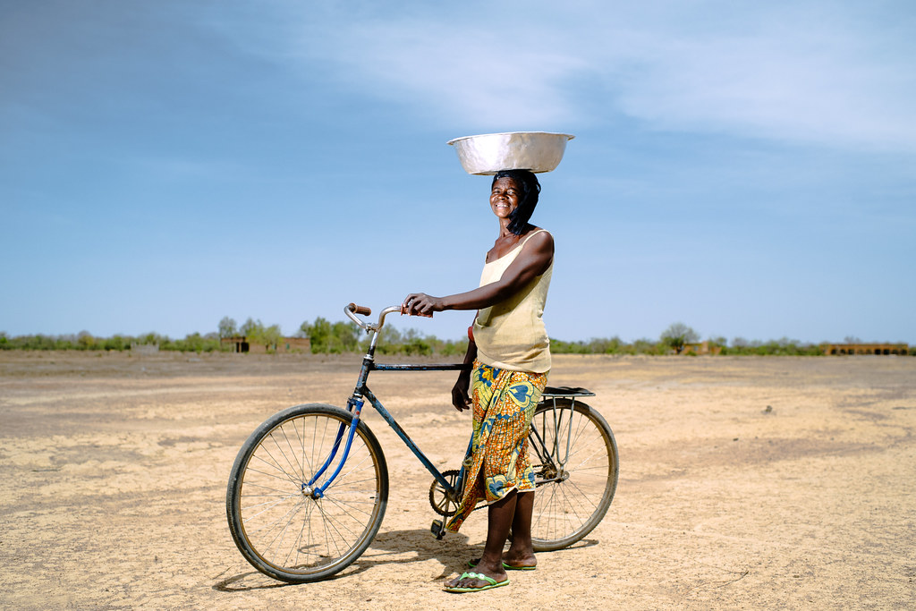 Awa, 64 years old, returning from collecting water 4 km away, Sorobouly village near Boromo, Burkina Faso.
