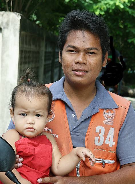 handsome motorcycle taxi driver and daughter
