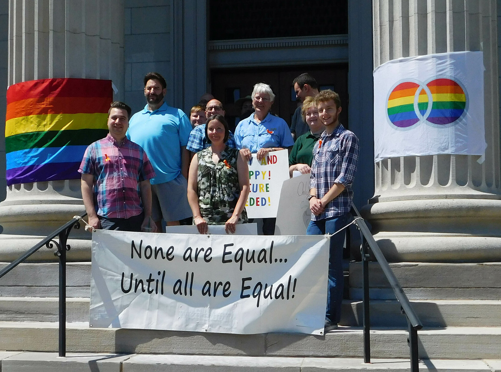 Standing on courthouse steps with banner