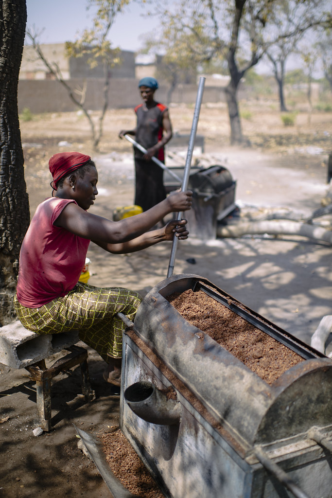 The crushed and roasted shea nuts will then be ground into a fine paste. Burkina Faso.