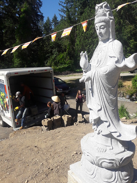 Sangha members unloading brick and preparing to build a garden wall to support marble statute of Lady Quan Yin, the bodhisattva, Vietnamese Buddhist Shrine, Federal Way, Washington, USA