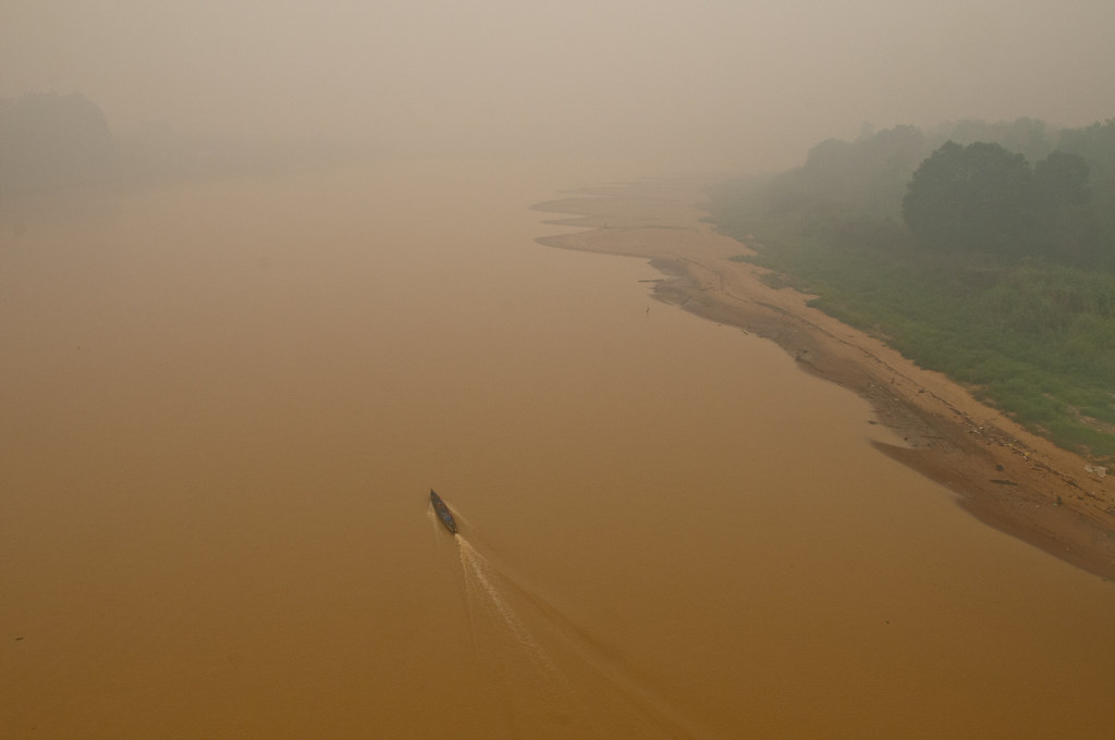 A boat is seen crossing through the mist on the Kahayan river, Palangka Raya, Central Kalimantan.