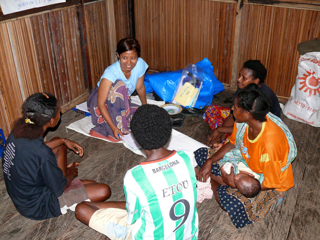 Women from the village gather together to talk to a CIFOR (Center For International Forestry Research) researcher, Papua, Indonesia.