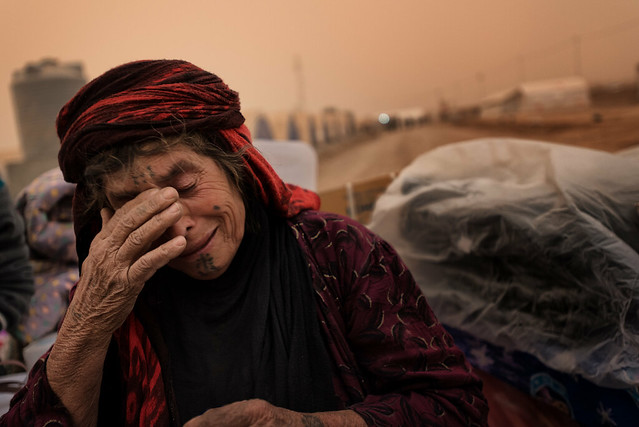Refugee Camp of Ghazer. Woman crying. Her husband has been interrogated for hours and she doesn't know where to go in this huge camp.