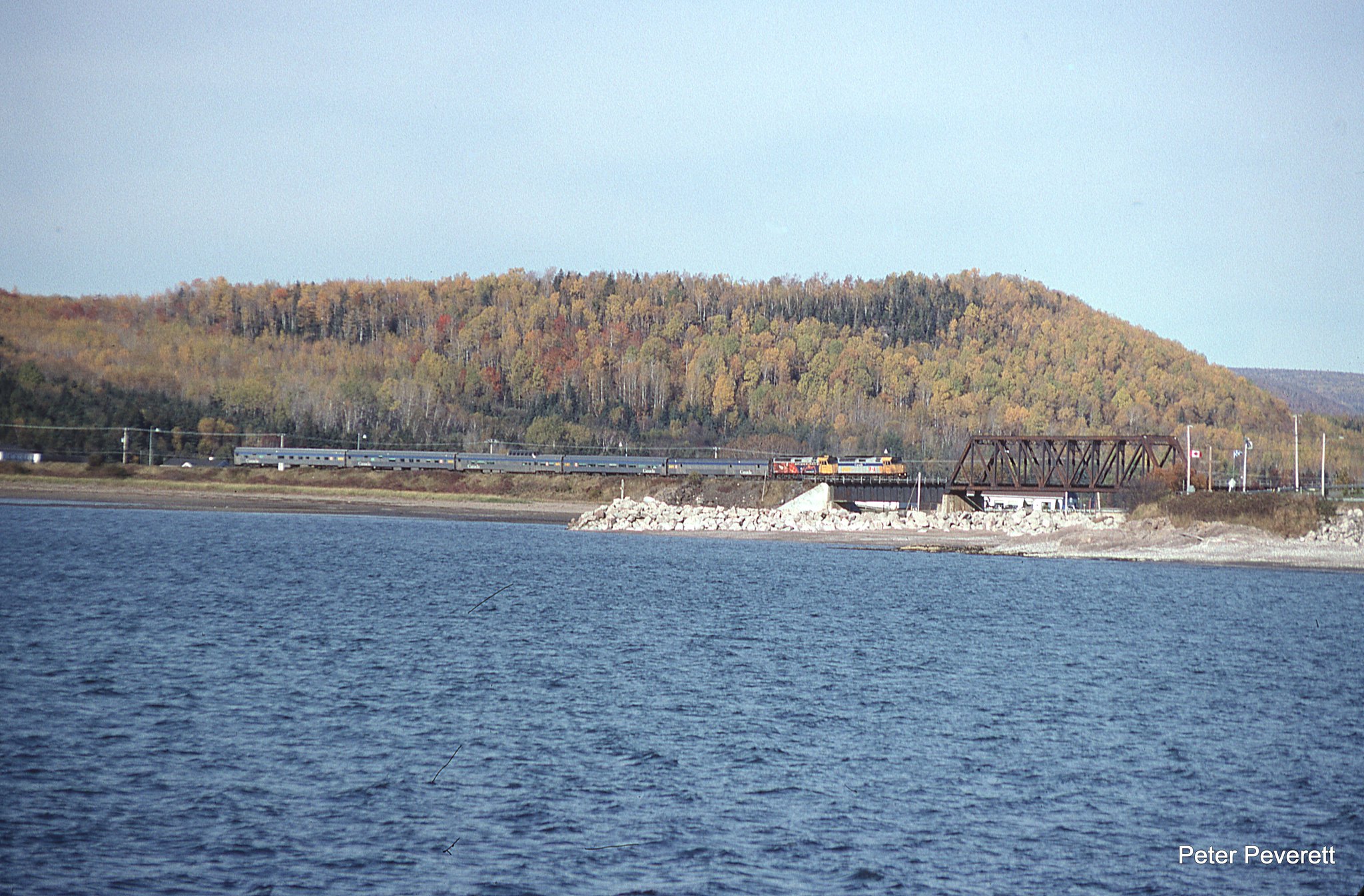 VIA Chaleur F40PH-2 # 6402, 6408 are eastbound at Port Daniel, Quebec Oct. 7, 2006.  They have just pulled away from a quick station stop and will shortly enter the short tunnel on the east side of town and continue on to Gaspe.