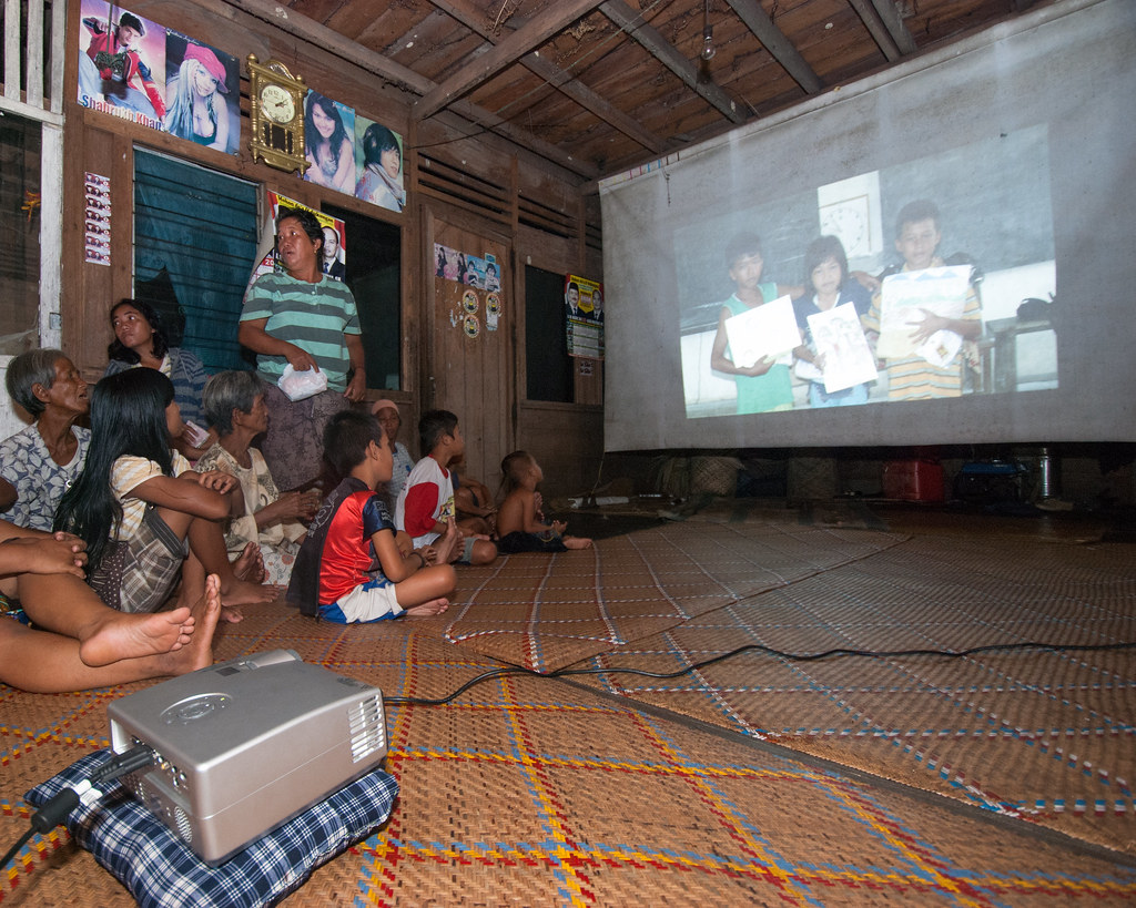 People of Pengerak village are watching video on their activities as part of orangutan awareness in their village, West Kalimantan,...