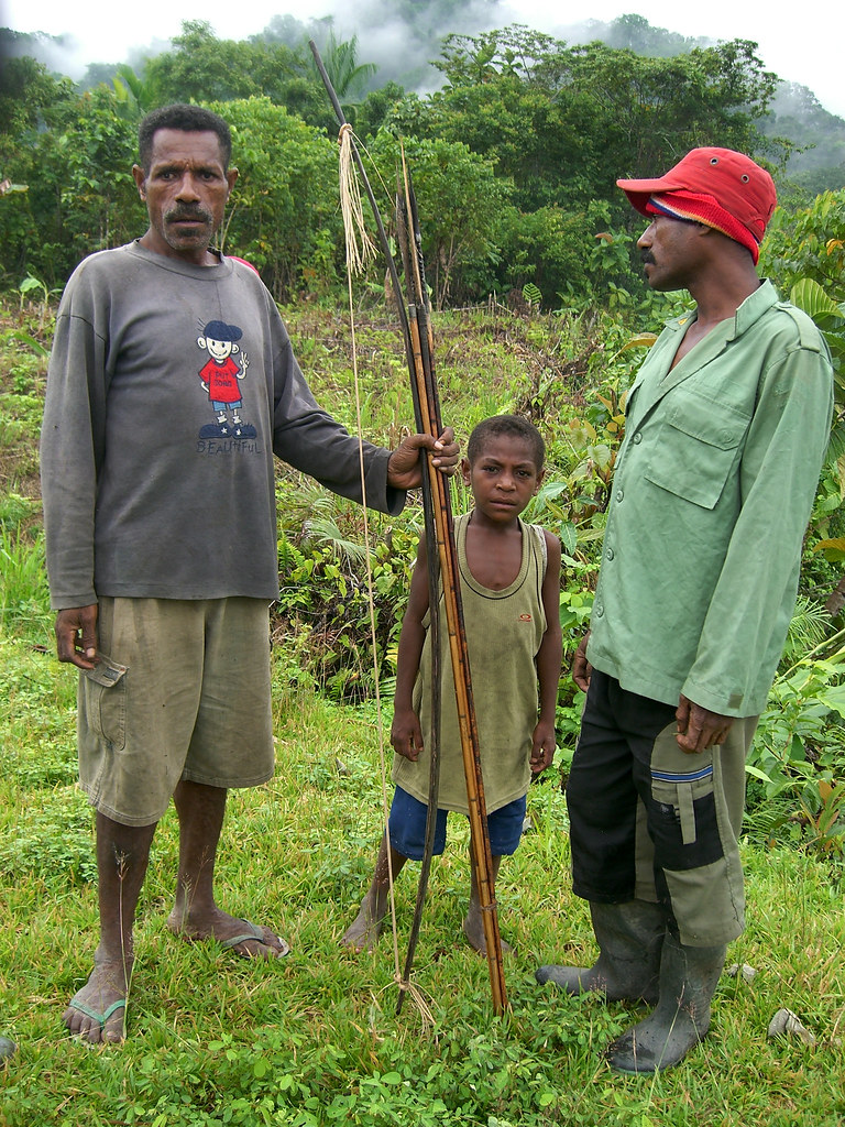 Kwerba people display their traditional hunting weapons. Papua, Indonesia.