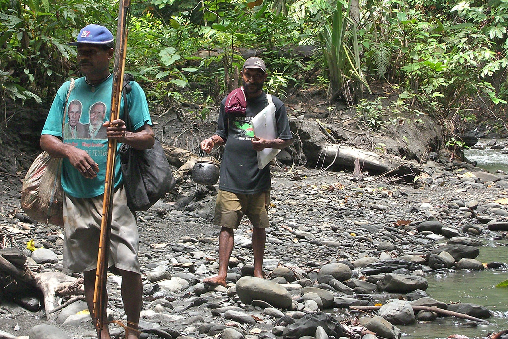 Members of Kwerba community walk in the jungle. Papua, Indonesia.