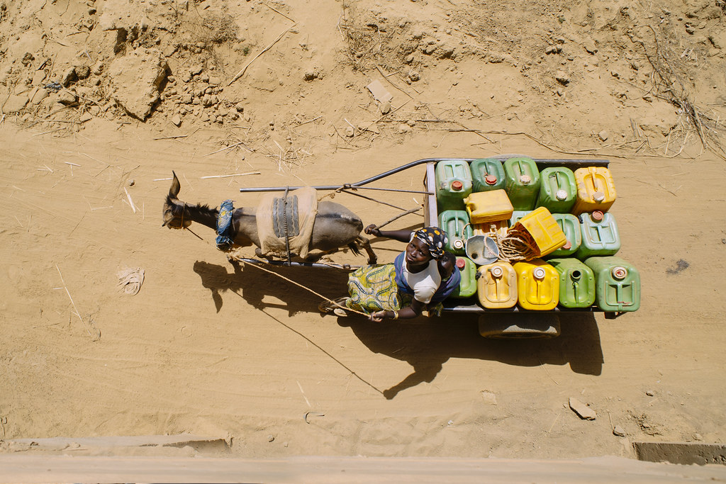 Water porter for gold panning, Sindri village, Burkina Faso.
