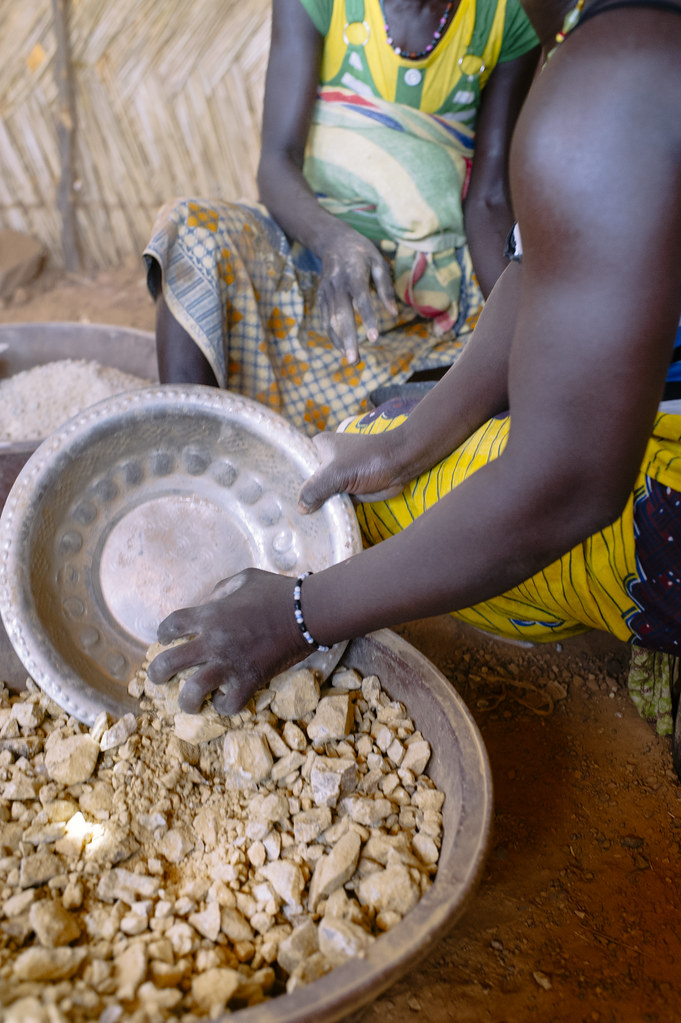 Zenab (left), 33 years old, and Ramatou, 38 years old, both farmers, crush gold ore. Most women have two jobs...