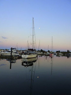 THE MOON AND REFLECTIONS ON A QUIET CLEAR EVENING IN THE BIRCH BAY VILLAGE MARINA,  WASHINGTON,  USA.