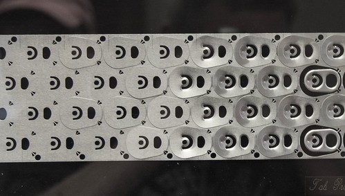 Aluminum  sheet showing progression in stamping out of beer can pop tops