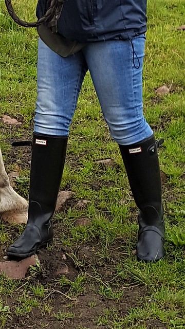 wife in tight jeans and hunter boots