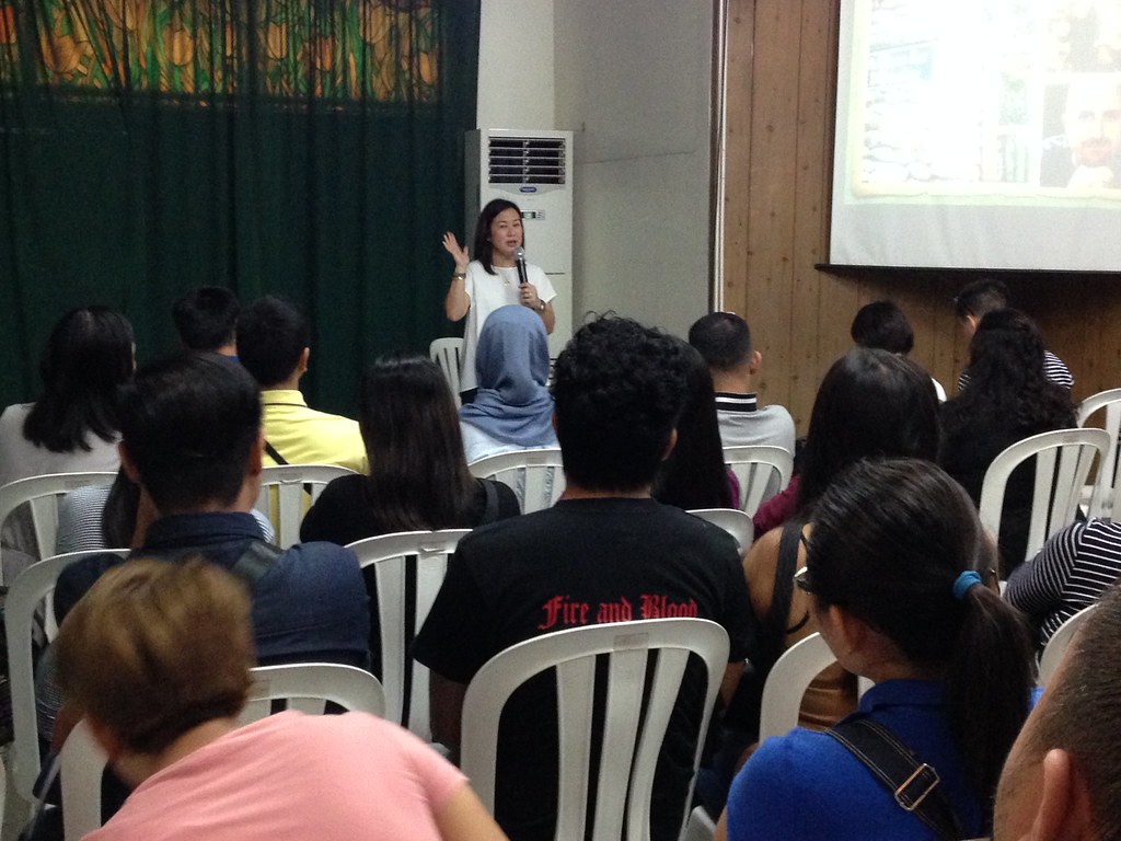 The image shows Ms. Michelle Tambunting speaking during the seminar.