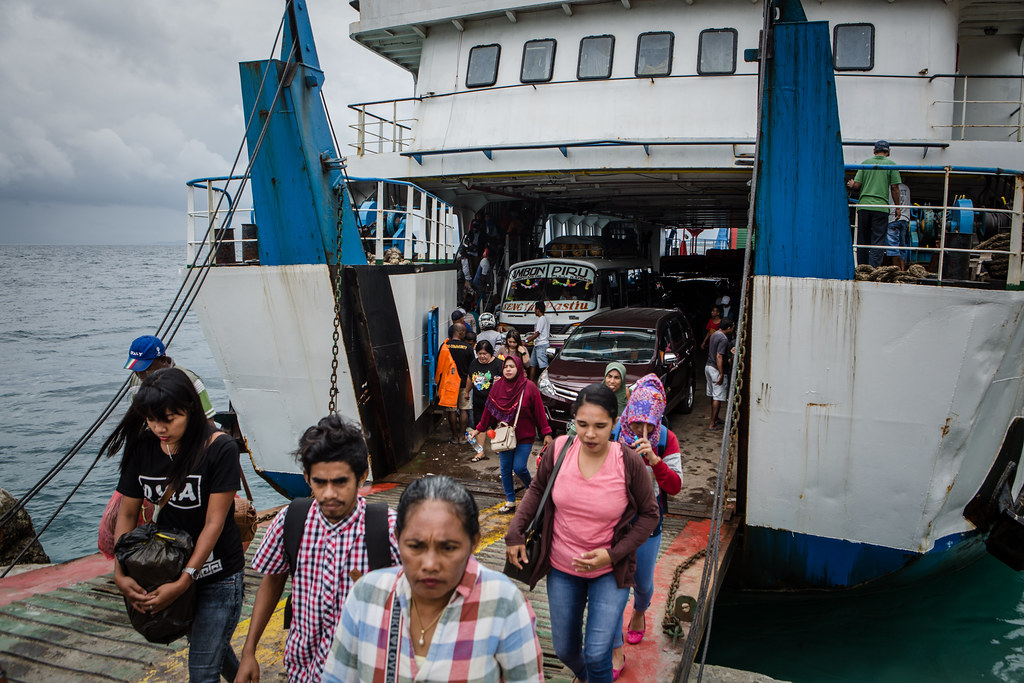 People disembark from a ferry at Waipirit port, West Seram regency, Maluku province, Indonesia on August 26, 2017.