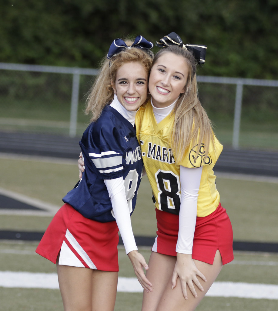 A couple of Roncalli cheerleaders flash their smile for the camera before t...