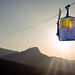 Honeymoon in the mountains. Sunset. Lovers kiss in the ski lift.