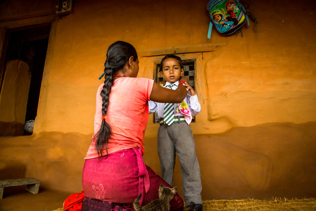 Sita, a wife left by her husband working overseas, is preparing her son to go to school. Most families in...