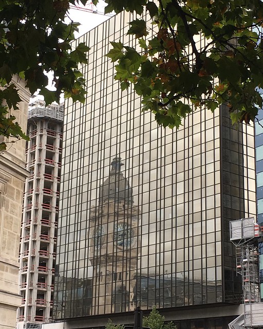 Gare de Lyon: clock tower reflected in modern building
