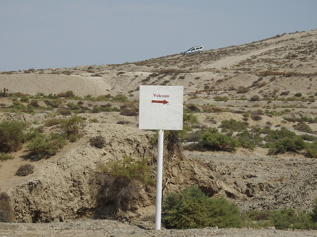 A sign points vaguely into the semi-arid desert