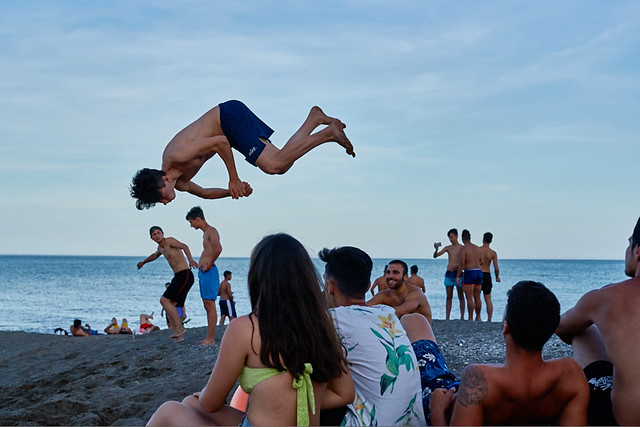 Young acrobats training on the beach, Pacífico barrio, Malaga, Spain