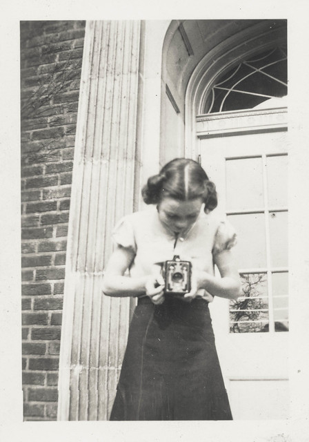 Little girl taking a photo with a box camera