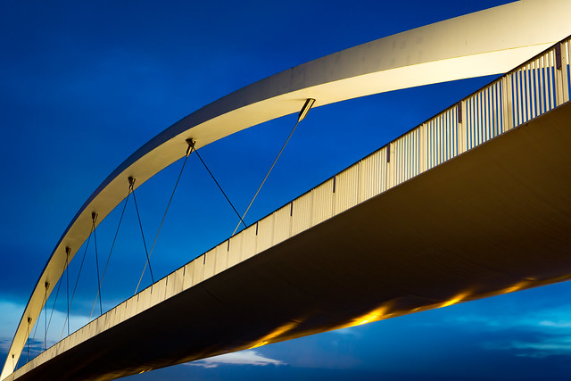 Bridge crossing a blue sky