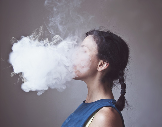 Woman smoking electronic cigarette creating cloud of vapor… | Flickr