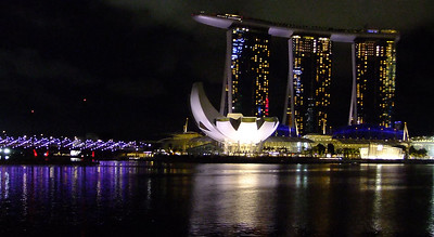 Singapore harbour at night with the 'boat' highrise and the 'Lotus' museum in the background