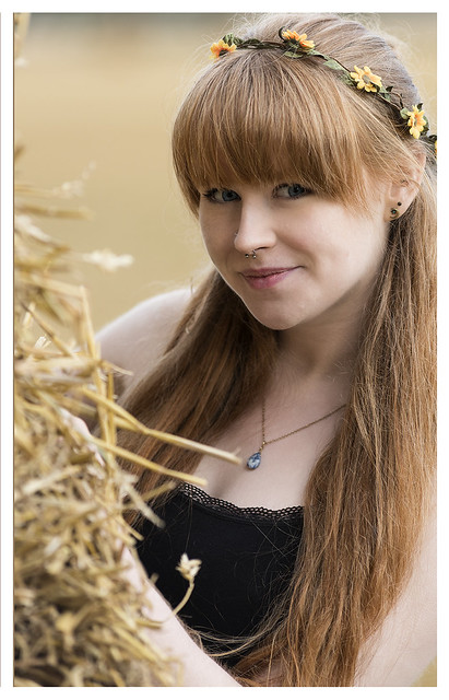 Zoe hiding behind the haystack