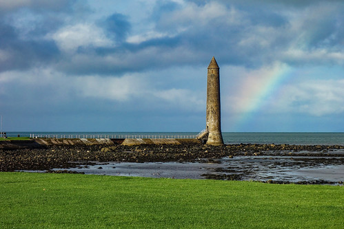 round tower lighthouse memorial chaine larne coantrim northern ireland rainbow sea sky clouds