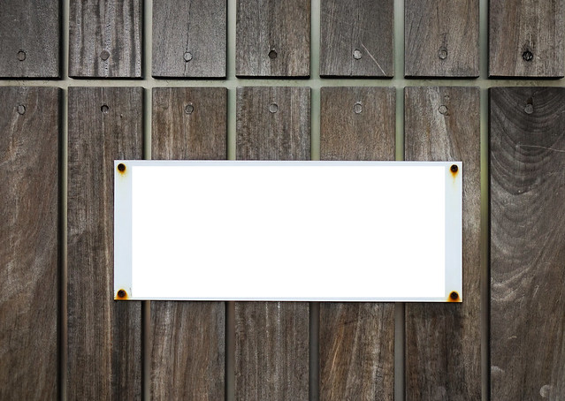 Sign board on wooden wall