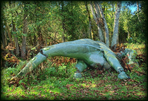 concrete dinosaur figure broken dinosaurgardens ossinkeealpena michigan