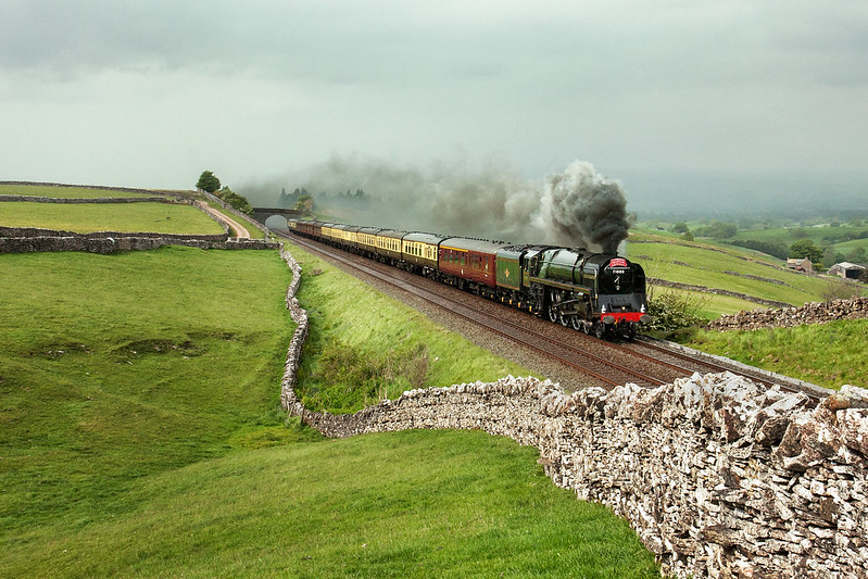 I have so few photographs of the BR '8P' Pacific in action that I was delighted to discover this un-processed image file in my archive. On 21st May 2011, 71000 'Duke of Gloucester' runs trouble-free on the 1 in 100 climb through the rain, but is showcased in a very brief bright spot at Birkett Common, near Kirkby Stephen, heading the return 1Z72 14:31 Carlisle to Gloucester  'Cumbrian Mountain Express'  charter.

Copyright Gordon Edgar  - All rights reserved. Please do not use any of these images without my explicit permission     