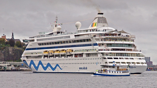 The commuter boat Gurli hurries past the cruise ship AIDAvita as she moves backwards from the quay, departing from Stockholm