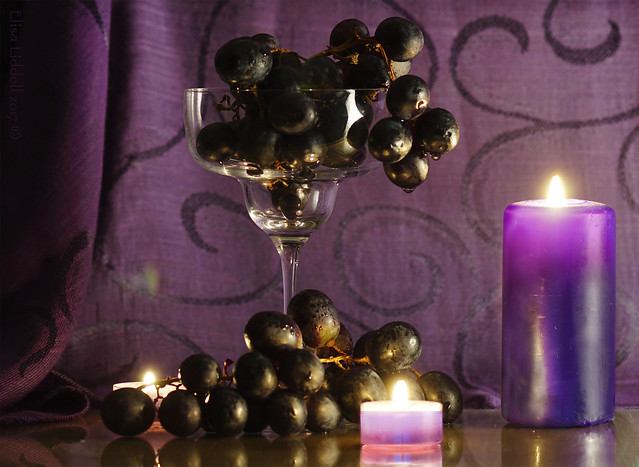 Black grapes by candlelight