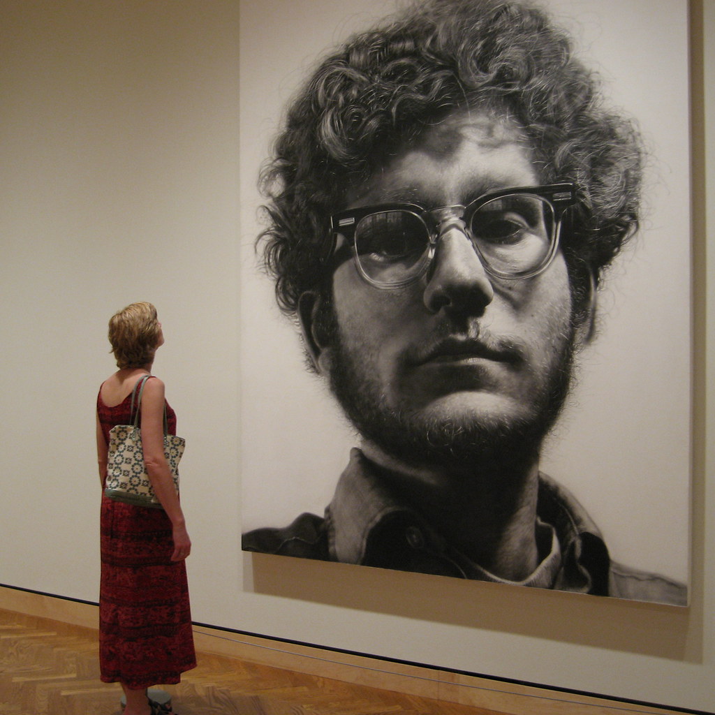 Chuck Close, Frank, 1969. 9’ high. Photo shows scale of Close’s works. Photo by TimWilson is licensed under CC BY 2.0