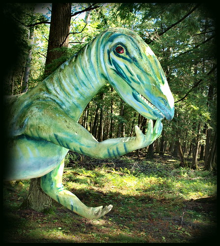 green dinosaur concrete figure striped dinosaurgardens alpenaossinkee michigan hungry gesturing