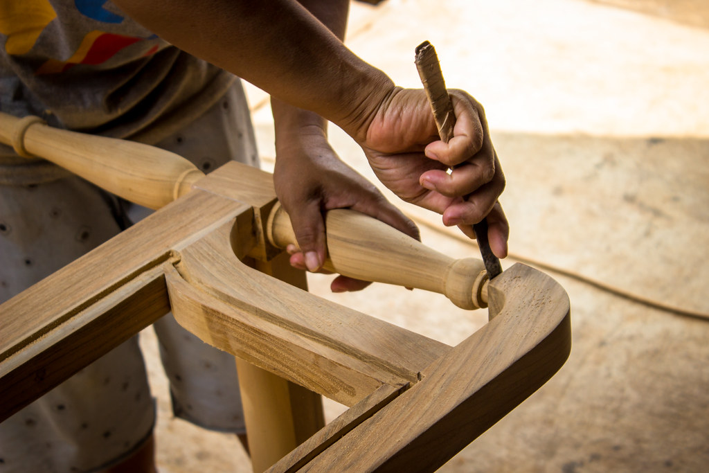 A woman sands furniture at a workshop in Jepara, Indonesia.