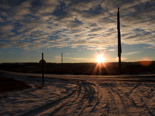 sunset sky snow utility pole road prairie